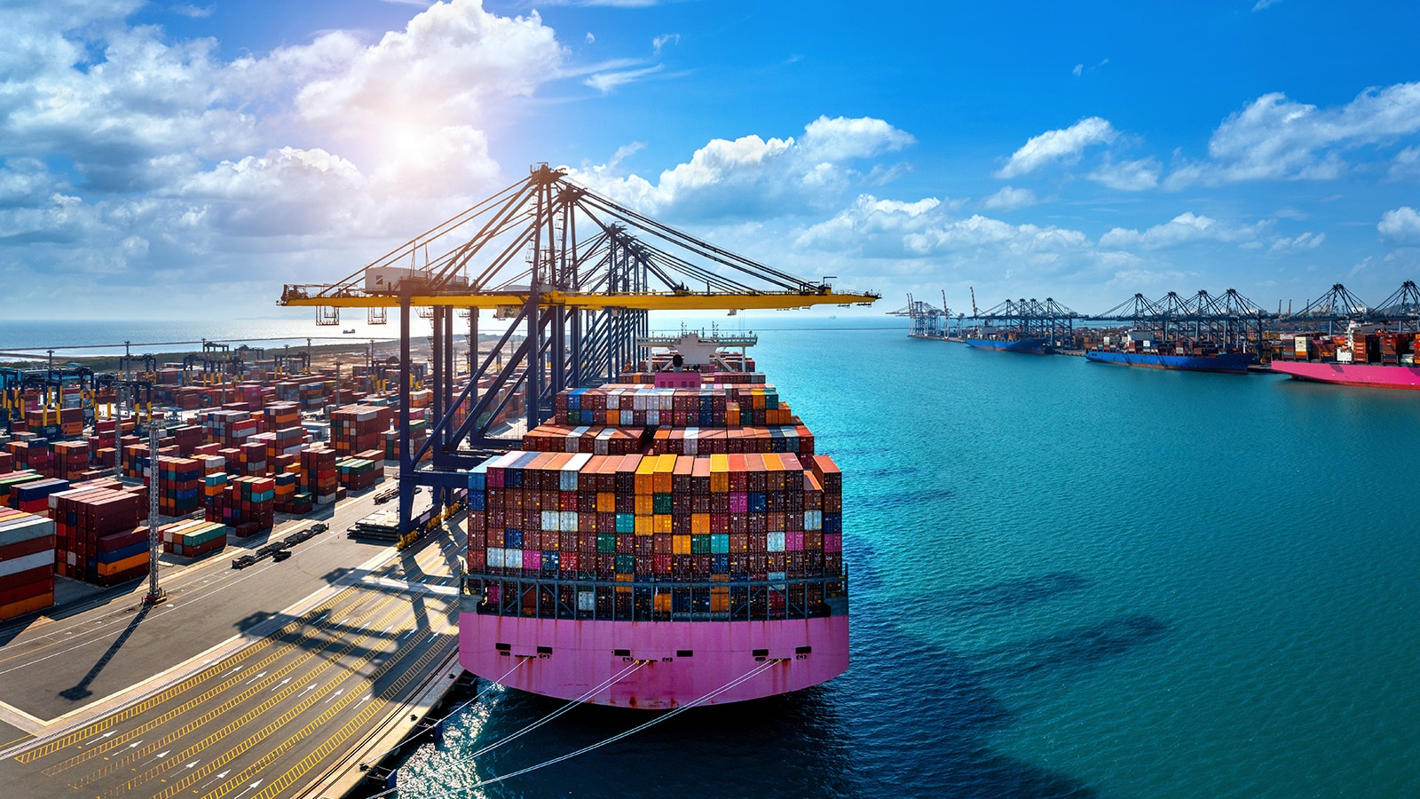 Aerial view of cargo ship and cargo container in harbor.